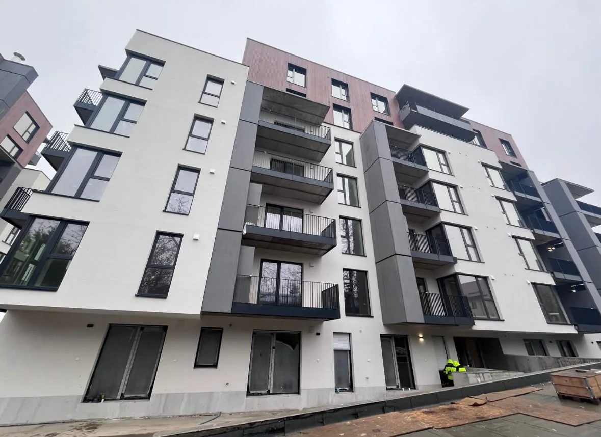 Completed urban façade with a vertical rhythm of windows and balconies