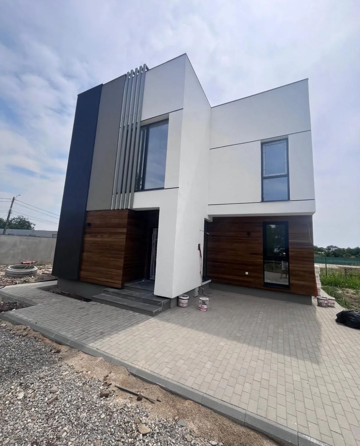 Completed modern home with timber accents and dark frames